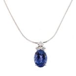 A TANZANITE AND DIAMOND PENDANT claw-set with an oval mixed-cut tanzanite weighing 8,32cts and