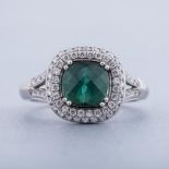 A GREEN TOURMALINE AND DIAMOND RING, BROWNS centred with a faceted cushion-cut green tourmaline