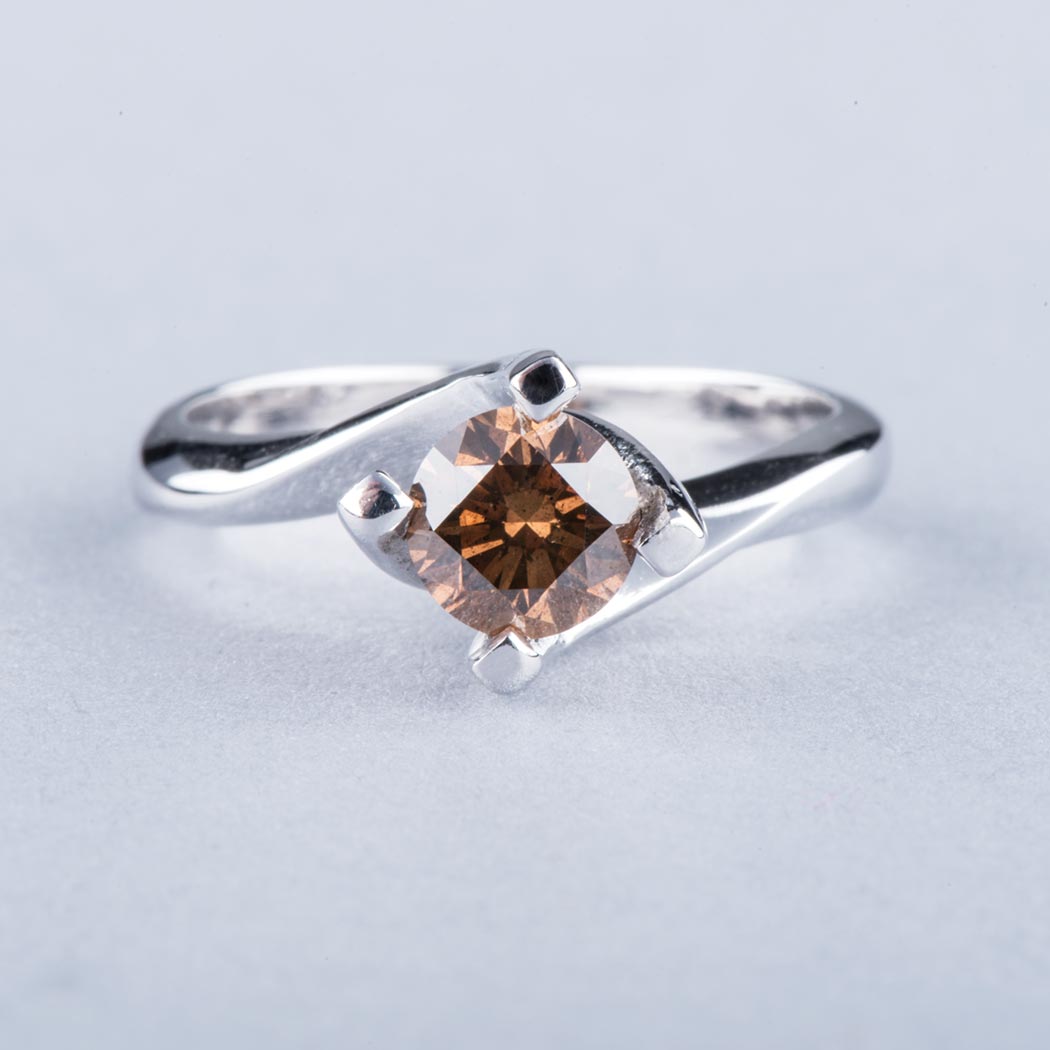 AN 18K WHITE GOLD AND COGNAC DIAMOND SOLITAIRE the approximately 1.18ct cognac diamond, clarity