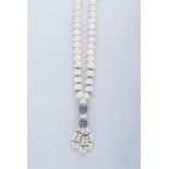 A PEARL AND SAPPHIRE NECKPIECE the pearls centred with a sapphire-encrusted ball, suspending another