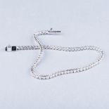 AN 18K WHITE GOLD TENNIS BRACELET the claw-set diamonds weighing approximately 1.80cts, colour I,