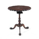 A GEORGE III MAHOGANY PIE-CRUST TILT-TOP TRIPOD TABLE the shaped circular top on a birds nest