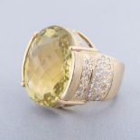 A CITRINE AND DIAMOND RING the broad band centred with a claw-set oval faceted citrine, the