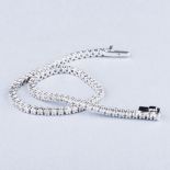 AN 18K WHITE GOLD TENNIS BRACELET the claw-set diamonds weighing approximately 3.00cts, colour I,
