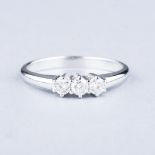 AN 18K WHITE GOLD TRILOGY RING the three diamonds weighing approximately 0.30ct in total, colour I/