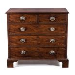 A GEORGE III MAHOGANY CHEST OF DRAWERS the rectangular moulded crossbanded top above a pair of short