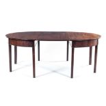 A GEORGE III MAHOGANY EXTENDING DINING TABLE