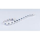 AN 18K WHITE GOLD, DIAMOND AND SAPPHIRE BRACELET 18 graduating sapphires, weighing approximately 6ct