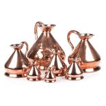 A SET OF SEVEN COPPER MEASURES, 19TH CENTURY in sizes , each shaped baluster body with everted