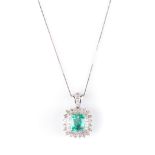 AN EMERALD AND DIAMOND PENDANT ON A CHAIN the claw-set cushion emerald, surrounded by two rows of