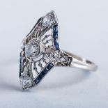 AN ART DECO DIAMOND AND SAPPHIRE RING centred with an old mine cut diamond, the surround embellished