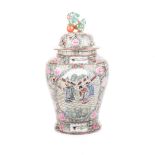 A CHINESE FAMILLE ROSE URN WITH COVER the tapering baluster body painted with panels depicting