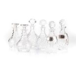 A MISCELLANEOUS COLLECTION OF CRYSTAL DECANTERS of various shapes and sizes the tallest 27cm high