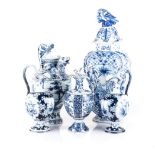 A MISCELLANEOUS COLLECTION OF DUTCH DELFT JARS AND EWERS of various shapes and sizes, chips