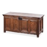 AN OAK COFFER, 18TH CENTURY the hinged, moulded, rectangular top enclosing a compartment, carved