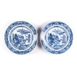 A PAIR OF CHINESE BLUE AND WHITE BARBED RIM PLATES each well painted with a landscape of pagodas and