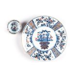 A CHINESE IMARI BLUE AND WHITE PLATE the central rondel painted with a flower filled jardinière,