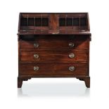 A GEORGE III MAHOGANY BUREAU the rectangular top above a hinged forefront, enclosing drawers and