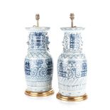 A NEAR PAIR OF CHINESE BLUE AND WHITE LAMPS each baluster shaped vase with everted rim and applied