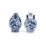 A NEAR PAIR OF SMALL CHINESE BLUE AND WHITE MOON FLASKS each with cylindrical mouth and oval base,