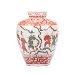 A CHINESE FAMILLE VERTE VASE of tapering ovoid form, the centre depicting figures in combat, above a