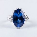 A TANZANITE AND DIAMOND SET centred with an oval-cut tanzanite, blue-violet in colour, flanked on