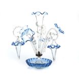 A GLASS FLOWER EPERGNE, CIRCA 1900 the circular waved bowl with metal mount supporting: 4 trumpets