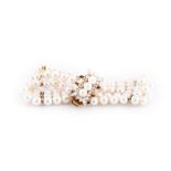 A PEARL AND DIAMOND BRACELET the three strand pearl bracelet on a clasp set with three pearls and