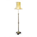 A BRASS STANDING LAMP on tapering Corinthian column support terminating in scrolling foliate