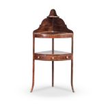 A GEORGE III WALNUT VENEERED CORNER WASHSTAND the bow-fronted top, centred by a circular aperture