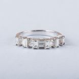 A HALF ETERNITY RING baguette cut diamonds, set in alternating directions half way around