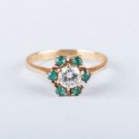 AN EMERALD AND DIAMOND RING the central round brilliant cut diamond, colour L, clarity SI2,