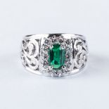 AN EMERALD AND DIAMOND RING the 0.84ct emerald cut emerald is set with 14 round brilliant cut