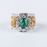 AN EMERALD AND DIAMOND RING the 1.53ct oval cut emerald is set with a cluster of 14 round