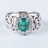 AN EMERALD AND DIAMOND RING the 1.50ct oval cut emerald is surrounded by 14 round brilliant cut