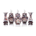 A JAPANESE IMARI GARNATURE comprising: 3 tapering ovoid jars with domed covers and shi-shi finial,