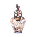 A JAPANESE IMARI VASE WITH COVER, MEIJI, 1868 – 1912 of tapering ovoid form, the body depicting a