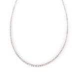 A DIAMOND NECKLACE designed as a line of graduated round brilliant-cut diamonds weighing