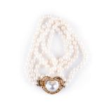 A MABE BLISTER PEARL AND DIAMOND NECKPIECE a double strand of pearls on a clasp set with a central