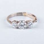 A DIAMOND TRILOGY RING centered with a round brilliant-cut diamond, approximately 0.70ct, colour H/I