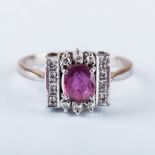 A TOURMALINE AND DIAMOND RING the central oval stone, possibly tourmaline, is claw set and