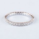 A DIAMOND ETERNITY RING claw set round brilliant-cut diamonds weighing approximately 0.60cts in