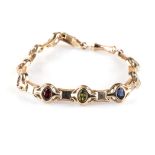 A SEMI PRECIOUS STONE BRACELET the oval cut stones of an assortment of amethyst, citrine,