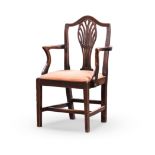 A GEORGE III OAK ARMCHAIR the curved top rail above a pierced splat, curved arms on curved supports,