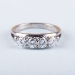 A FOUR STONE DIAMOND RING the four diamonds are claw set in between two bands, colour I/J, clarity