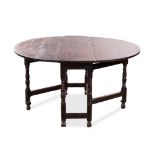 AN OAK GATELEG TABLE, LATE 19TH/EARLY 20TH CENTURY the hinged oval top above a plain frieze on