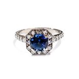 A SAPPHIRE AND DIAMOND RING centred with a round brilliant-cut sapphire weighing 0.79cts, the