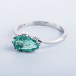 AN EMERALD RING the old pear-cut emerald is 12 claw-set off centre in acid tested 9k yellow gold
