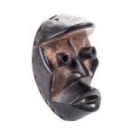 A BU GLE MASK, DAN, IVORY COAST wood and pigment 22cm high The Dan group form part of the Dan-Nguere