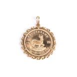 A COIN PENDANT set with a 1977 1oz Krugerrand, mounted in 18k yellow gold